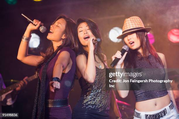 asian women singing onstage - girl band stock pictures, royalty-free photos & images