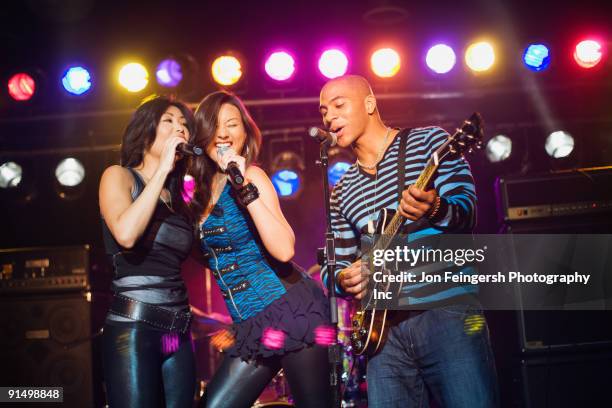 musical group performing onstage - rock group stock pictures, royalty-free photos & images