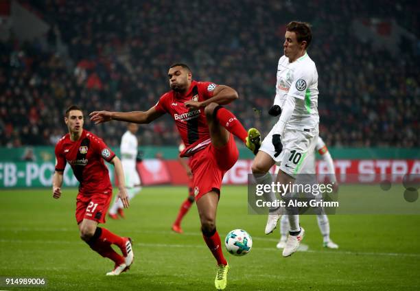 Jonathan Tah of Leverkusen tackles Max Kruse of Bremen during the DFB Cup quarter final match between Bayer Leverkusen and Werder Bremen at BayArena...