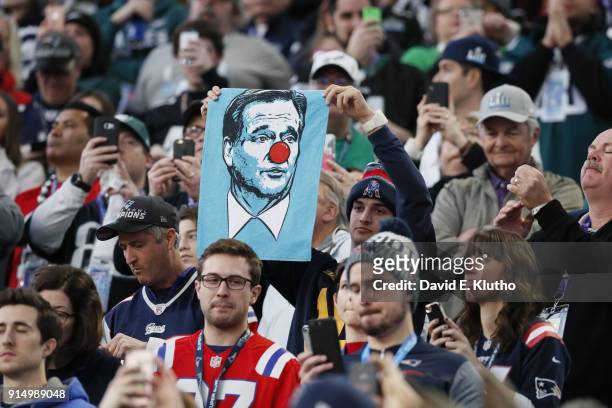 Super Bowl LII: New England Patriots fan in stands holding up poster of NFL commissioner Roger Goodell wearing a red nose during game vs Philadelphia...