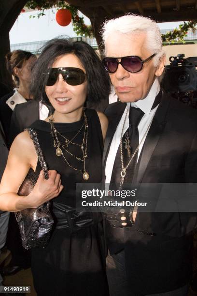 Maggie Cheung and Karl Lagerfeld attend the Chanel Pret a Porter show as part of Paris Womenswear Fashion Week Spring/Summer 2010 at Grand Palais on...