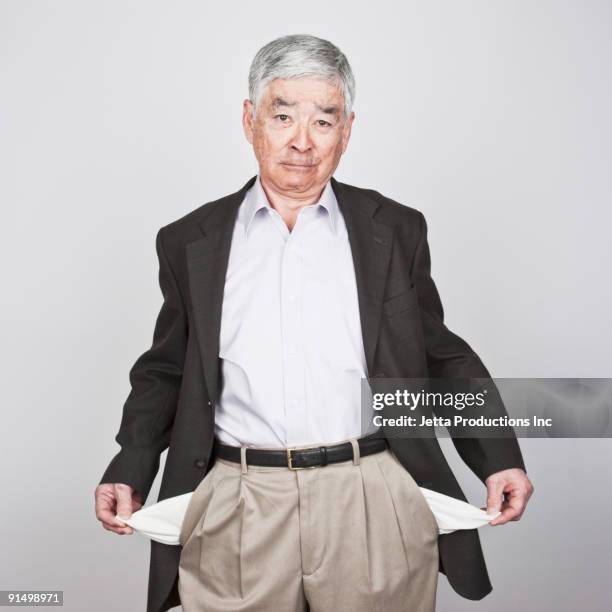 japanese man showing empty pockets - pocket square stock-fotos und bilder