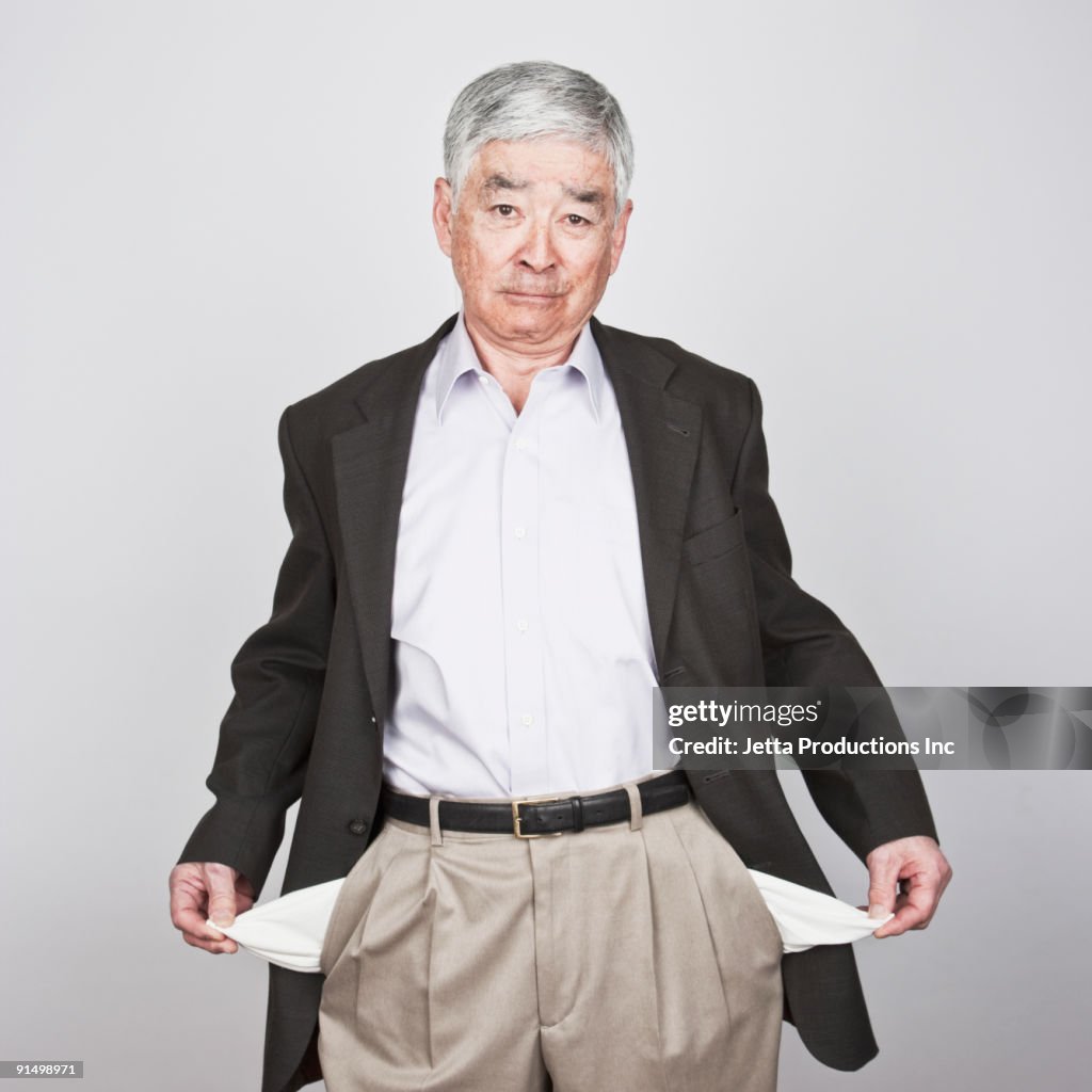 Japanese man showing empty pockets