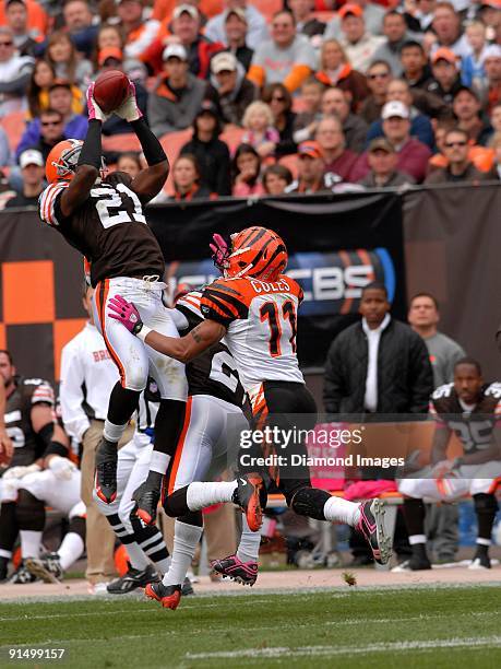 Defensive back Brodney Pool of the Cleveland Browns intercepts a pass intended for wide receiver Laveranues Coles of the Cincinnati Bengals during a...