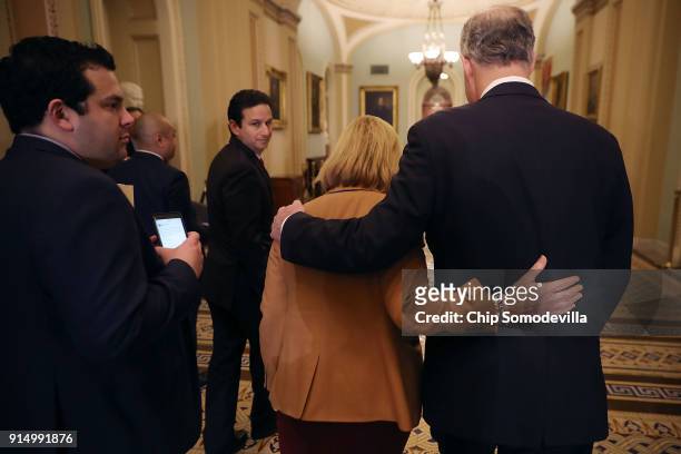 Sen. Robert Casey and Sen. Maggie Hassan walk away from a news conference following the weekly policy luncheon at the U.S. Capitol February 6, 2018...