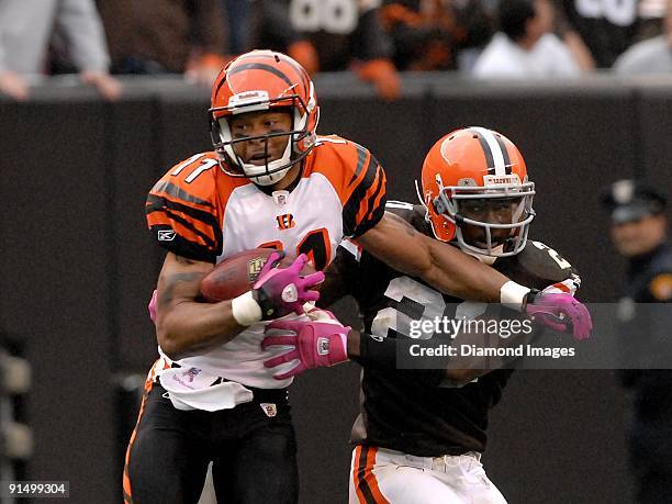 Wide receiver Laveranues Coles of the Cincinnati Bengals battles defensive back Brodney Pool of the Cleveland Browns after catching a pass during a...