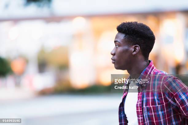 profile of young african-american man outdoors - man side way looking stock pictures, royalty-free photos & images