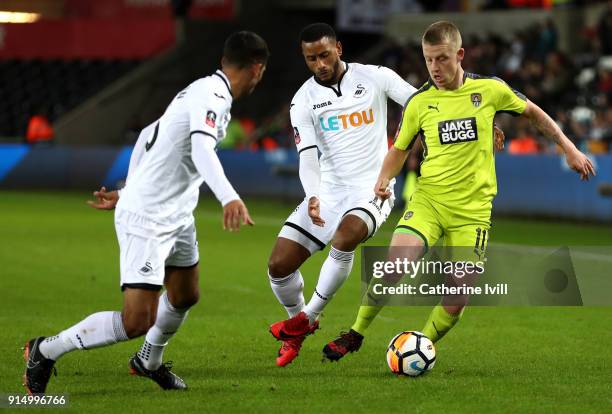 Terry Hawkridge of Notts County is challenged by Luciano Narsingh of Swansea City during The Emirates FA Cup Fourth Round match between Swansea City...