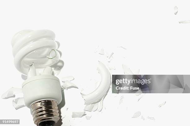broken compact fluorescent light bulb - broken light bulb stock pictures, royalty-free photos & images