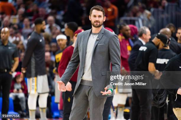 Kevin Love of the Cleveland Cavaliers talks to players on the Houston Rockets bench during a time-out during the second half at Quicken Loans Arena...