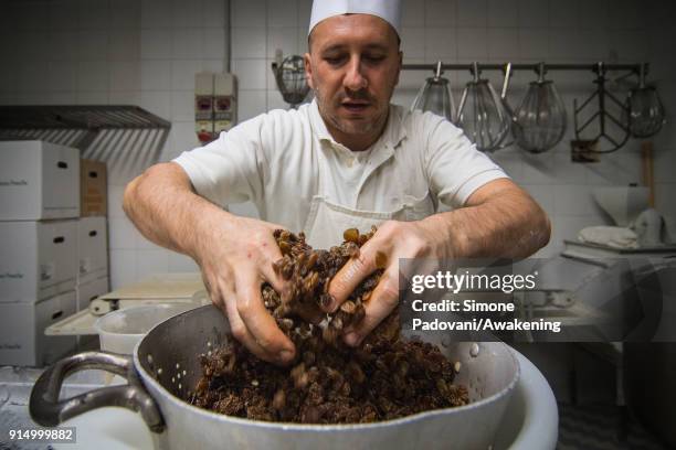 Pastry chef prepares the raisin for Frittelle, a typical sweet of Venetian carnival, in Rosa Salva laboratory on February 6, 2018 in Venice, Italy....