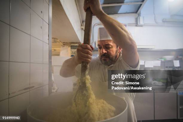 Pastry chef prepares the dought of Frittelle, a typical sweet of Venetian carnival, for cooking in Rosa Salva laboratory on February 6, 2018 in...