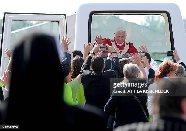 Pope Benedict XVI waves as he leaves following Pontifical mass at Stara Boleslav, some 25 Kms northeast of Prague on September 28, 2009. Pope...