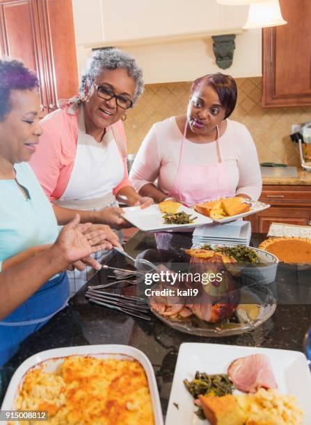 african-american women serving home cooked meal - american pie reunion stock pictures, royalty-free photos & images