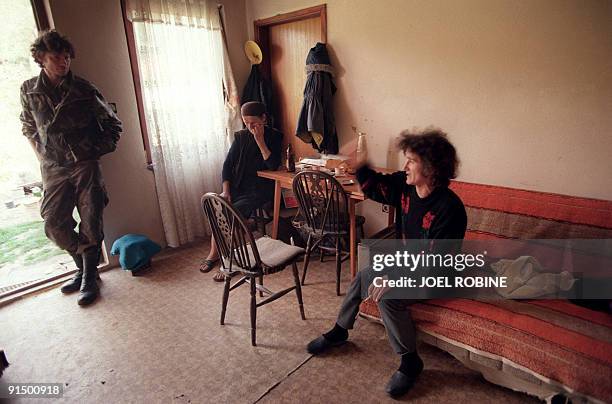 Croatian soldier watches over two Serbian women on May 06, 1995 in a house near Okucani which Croation forces captured from rebels Serbs during their...