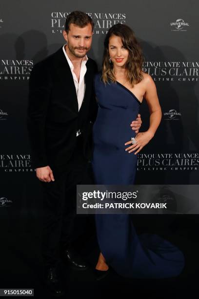 Actor Jamie Dornan poses with his wife Amelia Warner as they arrive to attend 'Fifty Shades Freed - 50 Nuances Plus Claires' Premiere at Salle Pleyel...