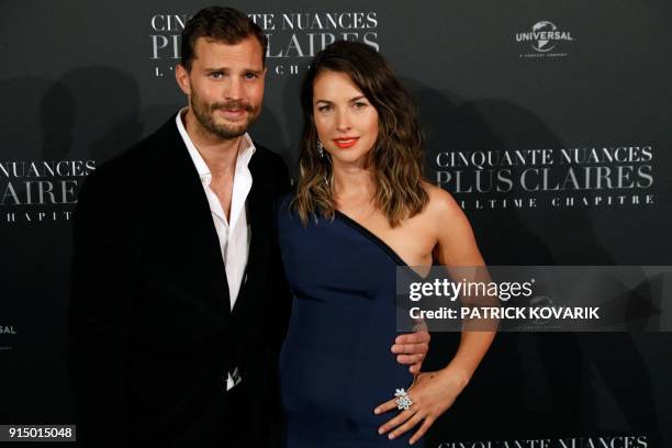 Actor Jamie Dornan poses with his wife Amelia Warner as they arrive to attend 'Fifty Shades Freed - 50 Nuances Plus Claires' Premiere at Salle Pleyel...