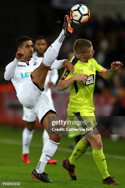 Kyle Naughton of Swansea City and Terry Hawkridge of Notts County in action during The Emirates FA Cup Fourth Round match between Swansea City and...