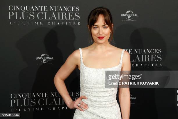 Actress Dakota Johnson poses as she arrives to attend 'Fifty Shades Freed - 50 Nuances Plus Claires' Premiere at Salle Pleyel in Paris on February 6,...