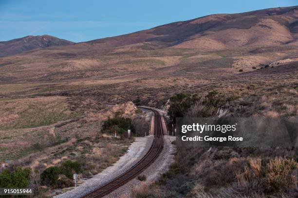 The coastal Amtrak train tracks running along a bluff above the beach and campground are viewed on February 3 in Jalama Beach, California. Because of...