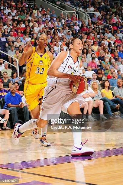Diana Taurasi of the Phoenix Mercury drives the ball past Tina Thompson of the Los Angeles Sparks in Game Two of the Western Conference Finals during...