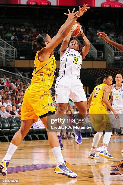 Temeka Johnson of the Phoenix Mercury shoots the ball over Tina Thompson of the Los Angeles Sparks in Game Two of the Western Conference Finals...