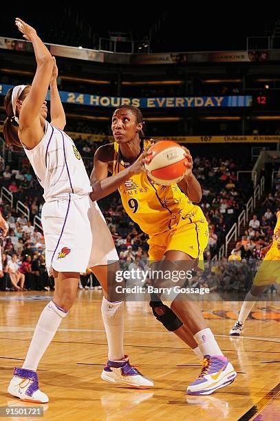 Lisa Leslie of the Los Angeles Sparks drives the ball against Tangela Smith of the Phoenix Mercury in Game Three of the Western Conference Finals...