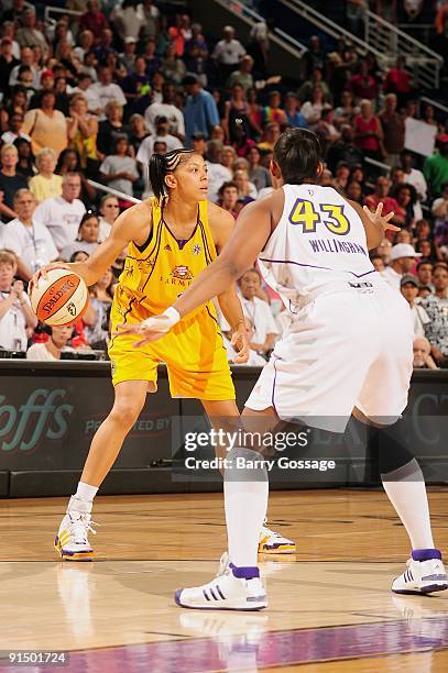 Candace Parker of the Los Angeles Sparks drives the ball against Le'coe Willingham of the Phoenix Mercury in Game Three of the Western Conference...