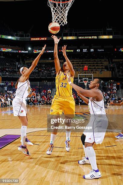 Tina Thompson of the Los Angeles Sparks puts up a shot between Tangela Smith and Le'coe Willingham of the Phoenix Mercury in Game Three of the...