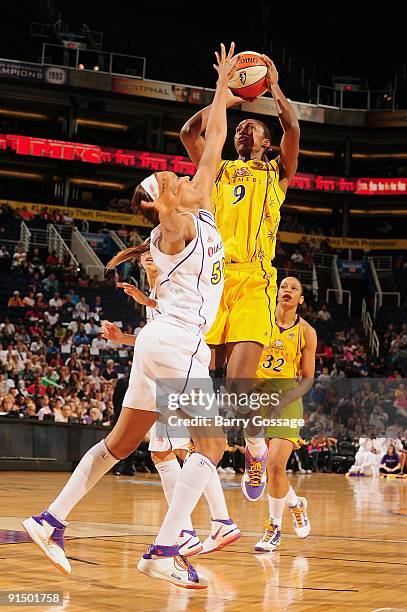 Lisa Leslie of the Los Angeles Sparks puts up a shot against Tangela Smith of the Phoenix Mercury in Game Three of the Western Conference Finals...