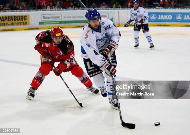 Matt Dzieduszycki of Hannover and Felix Petermann of Mannheim battle for the puck during the DEL match between Hannover Scorpions and Adler Mannheim...