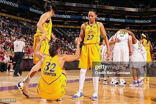 Tina Thompson of the Los Angeles Sparks is helped up by teammates Candace Parker and Betty Lennox in Game Three of the Western Conference Finals...