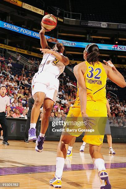 Temeka Johnson of the Phoenix Mercury lays up a shot against Tina Thompson of the Los Angeles Sparks in Game Three of the Western Conference Finals...