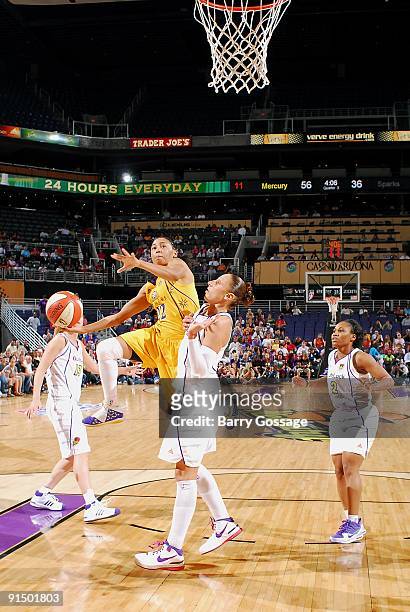 Betty Lennox of the Los Angeles Sparks puts up a shot against Diana Taurasi of the Phoenix Mercury in Game Three of the Western Conference Finals...