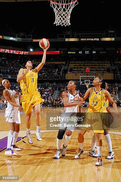 Candace Parker of the Los Angeles Sparks puts up a shot between Tangela Smith and Le'coe Willingham of the Phoenix Mercury in Game Two of the Western...