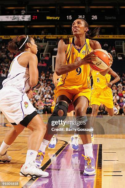 Lisa Leslie of the Los Angeles Sparks drives the ball against Ketia Swanier of the Phoenix Mercury in Game Two of the Western Conference Finals...