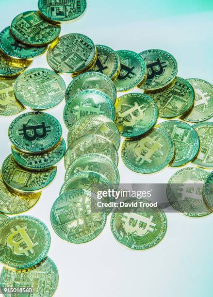 physical version of bitcoin coin aka virtual money. - david trood stock pictures, royalty-free photos & images
