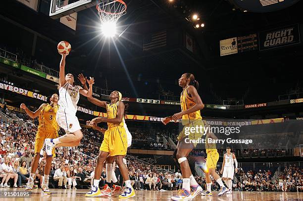 Penny Taylor of the Phoenix Mercury lays up a shot against Candace Parker and DeLisha Milton-Jones of the Los Angeles Sparks in Game Two of the...