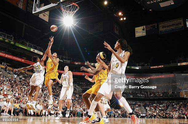 Candace Parker of the Los Angeles Sparks puts up a shot between Cappie Pondexter and Nicole Ohlde of the Phoenix Mercury in Game Two of the Western...