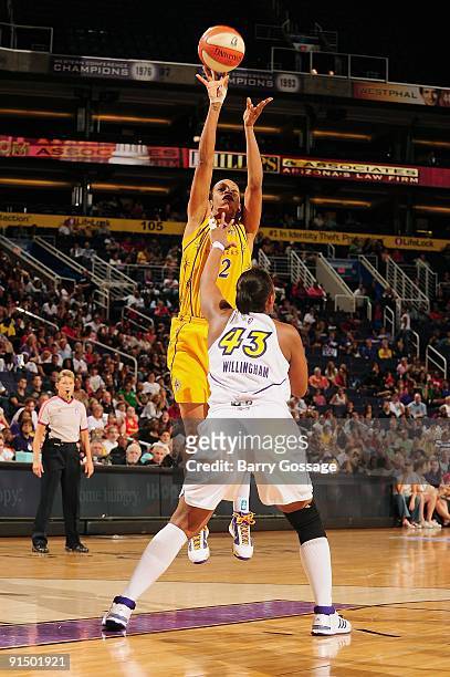 Tina Thompson of the Los Angeles Sparks shoots the ball over Le'coe Willingham of the Phoenix Mercury in Game Two of the Western Conference Finals...