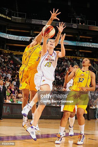 Penny Taylor of the Phoenix Mercury lays up a shot against Candace Parker and Tina Thompson of the Los Angeles Sparks in Game Two of the Western...