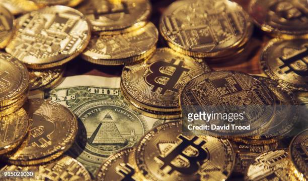 physical version of bitcoin coin aka virtual money. - david trood stock pictures, royalty-free photos & images