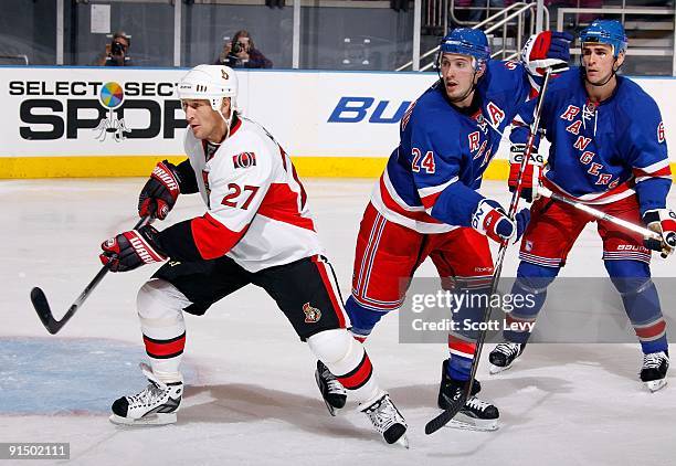 Alex Kovalev of the Ottawa Senators skates against Ryan Callahan and Wade Redden of the New York Rangers on October 3, 2009 at Madison Square Garden...