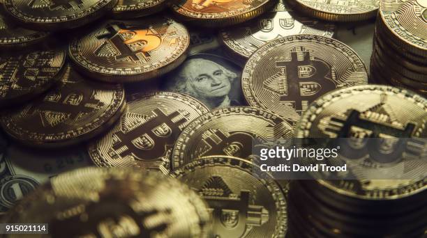 physical version of bitcoin coin aka virtual money. - david trood stock pictures, royalty-free photos & images