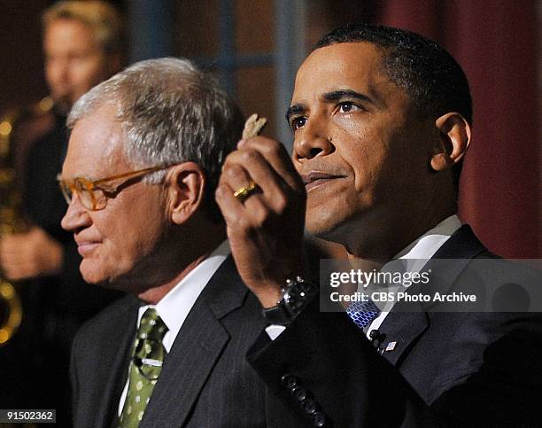 President of the United States Barack Obama holds up the dried heart shape potato that an audience member brought to the Late Show two years ago,...