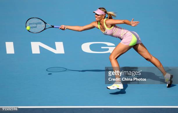 Maria Sharapova of Russia returns a shot against Victoria Azarenka of Belarus in her first round match during day five of the 2009 China Open at the...