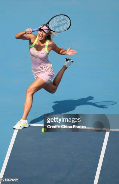 Maria Sharapova of Russia returns a shot against Victoria Azarenka of Belarus in her first round match during day five of the 2009 China Open at the...