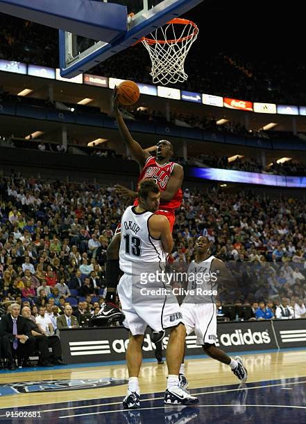 Luol Deng of the Chicago Bulls scores the layup against Mehmet Okur of the Utah Jazz during the NBA pre-season game as part of the 2009 NBA Europe...