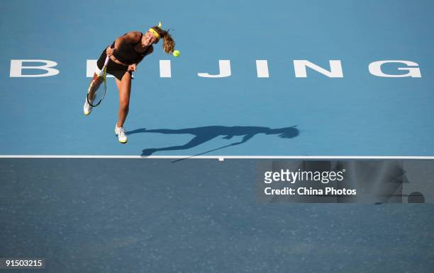 Victoria Azarenka of Belarus serves against Maria Sharapova of Russia in her first round match during day five of the 2009 China Open at the National...