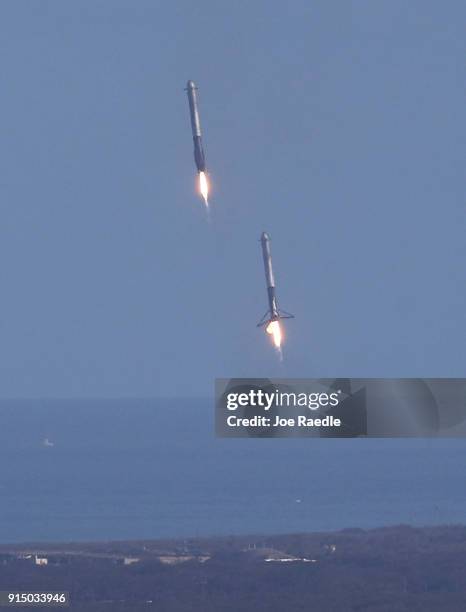 Two of the boosters land at Cape Canaveral Air Force Station after the launch of SpaceX Falcon Heavy rocket from launch pad 39A at Kennedy Space...